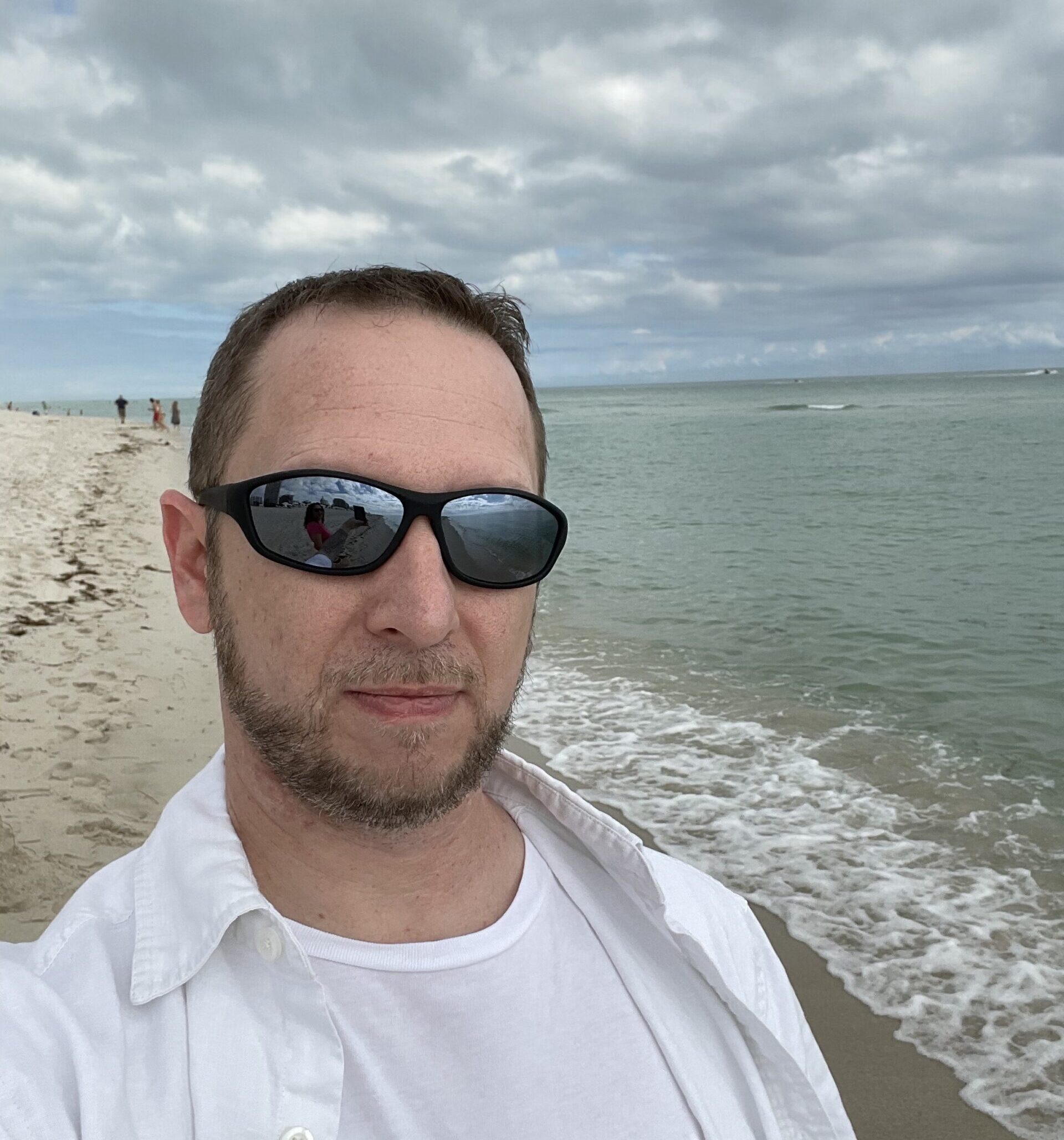 Image of Trent Wyman walking along the beach.